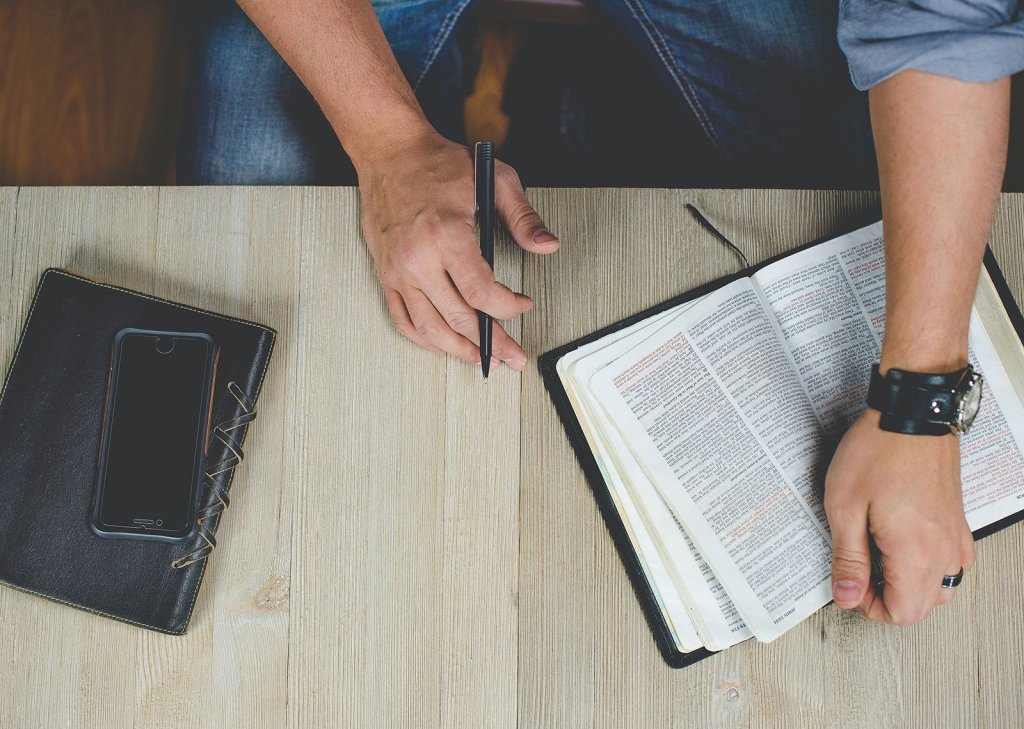 Photo of a man studying the Bible