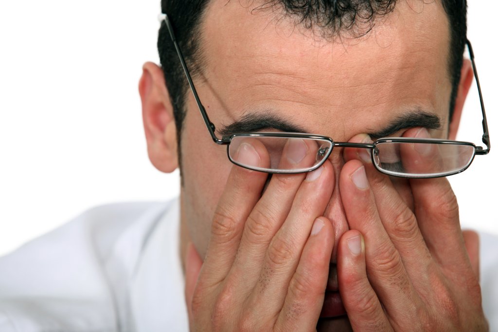 Tired man rubbing his eyes Tired man rubbing his eyes